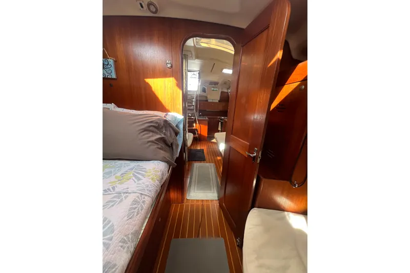 Pelagia Yacht Photos Pics Interior of 1998 Hunter Passage 450 yacht with wooden finish and cozy cabin.