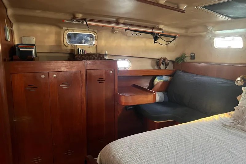 Pelagia Yacht Photos Pics Cozy interior of 1998 Hunter Passage 450 sailboat with wooden cabinets and seating area.