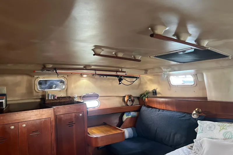 Pelagia Yacht Photos Pics Cozy interior of 1998 Hunter Passage 450 sailboat with wooden cabinets and seating area.