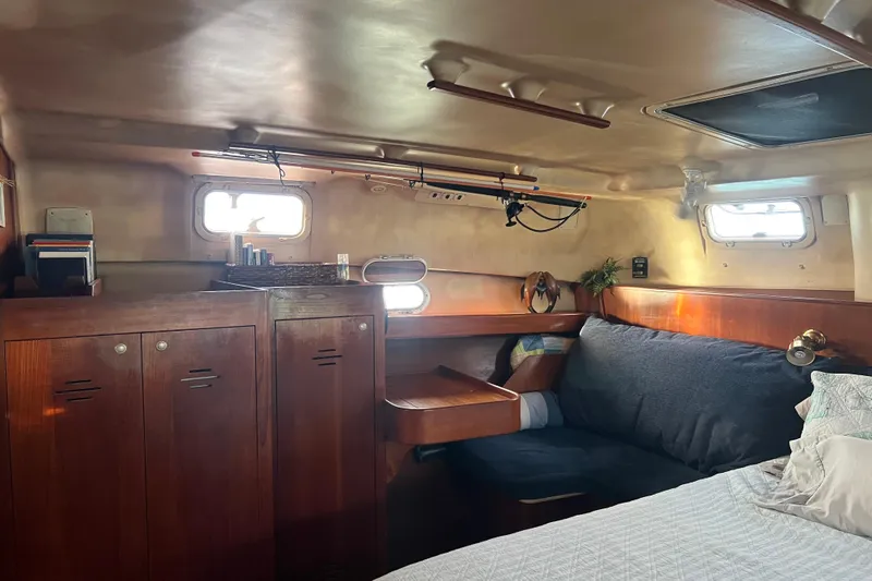 Pelagia Yacht Photos Pics Cozy interior of 1998 Hunter Passage 450 sailboat with wooden cabinets and seating area.