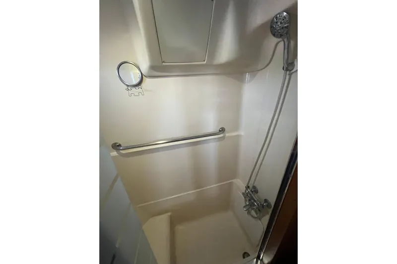 Pelagia Yacht Photos Pics Shower area in 1998 Hunter Passage 450 yacht with handheld showerhead and grab bar.