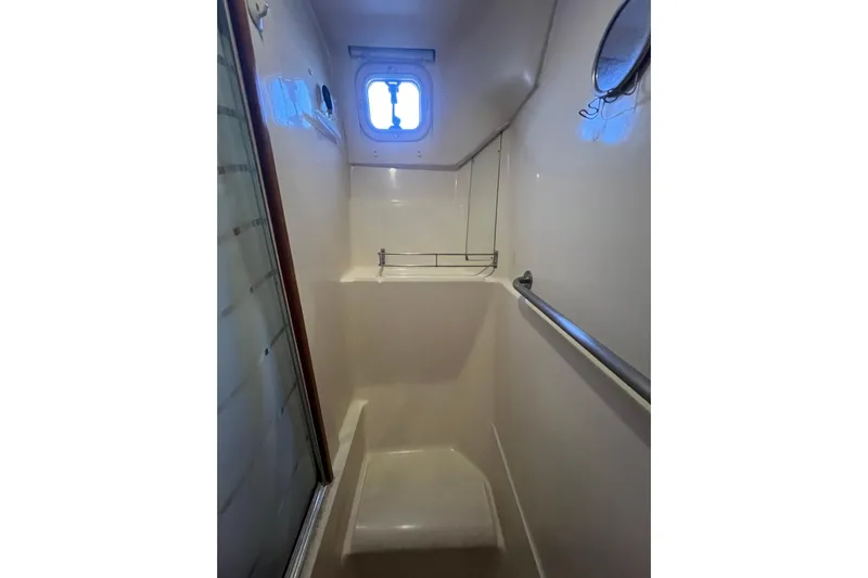 Pelagia Yacht Photos Pics Compact shower area in 1998 Hunter Passage 450 yacht with window and handrail.