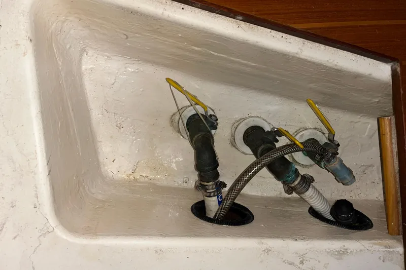 Pelagia Yacht Photos Pics Plumbing system in 1998 Hunter Passage 450 sailboat with yellow-handled valves.