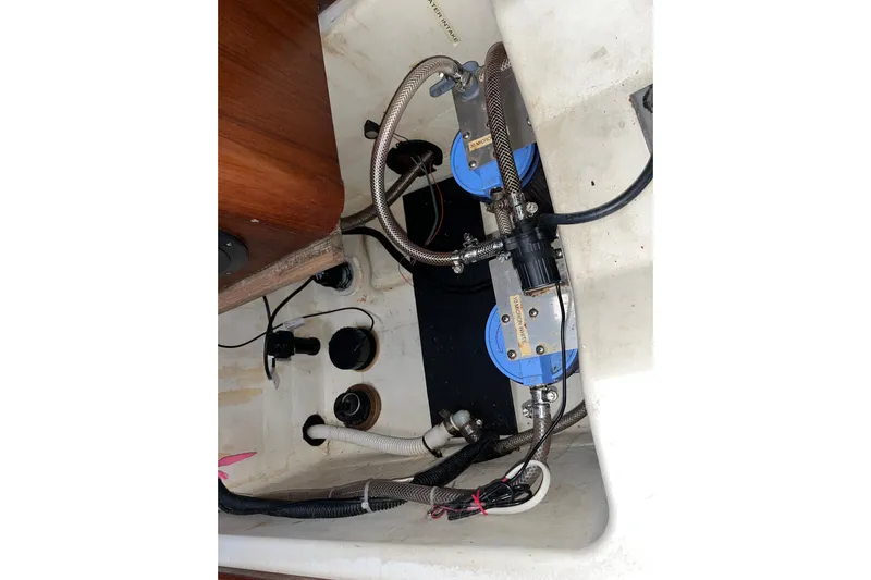 Pelagia Yacht Photos Pics Engine compartment of a 1998 Hunter Passage 450 sailboat, showing hoses and components.