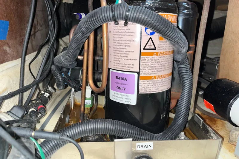 Pelagia Yacht Photos Pics Electrical wiring and R410A refrigerant label inside a 1998 Hunter Passage 450 boat.