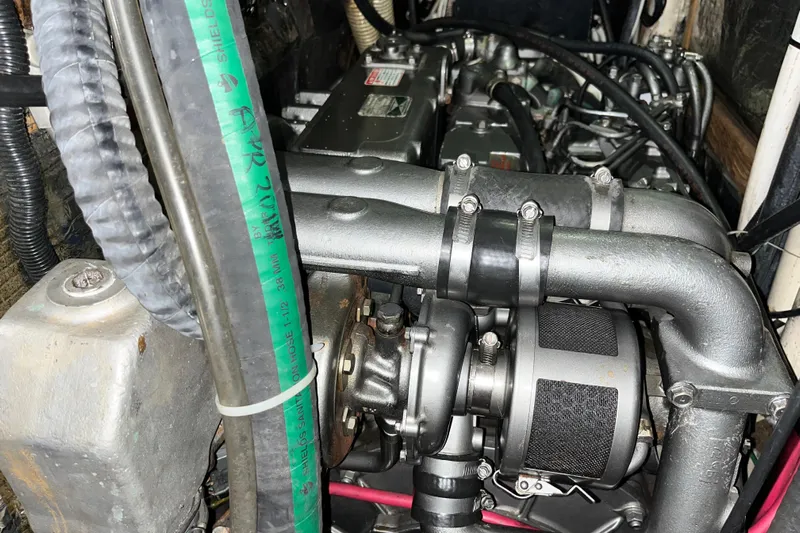 Pelagia Yacht Photos Pics Engine compartment of a 1998 Hunter Passage 450 sailboat, showcasing mechanical components and hoses.