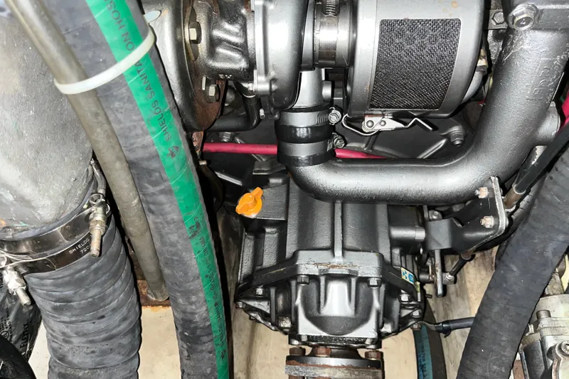 Pelagia Yacht Photos Pics Engine compartment of a 1998 Hunter Passage 450 sailboat, showing mechanical components and hoses.