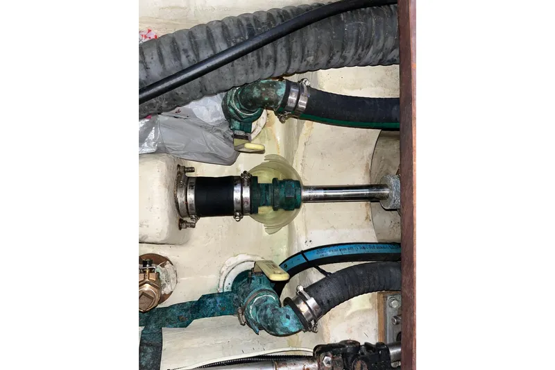 Pelagia Yacht Photos Pics Engine compartment of a 1998 Hunter Passage 450 sailboat, showing hoses and fittings.