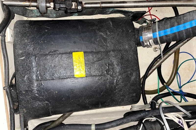 Pelagia Yacht Photos Pics Engine compartment of a 1998 Hunter Passage 450 sailboat, showing hoses and components.