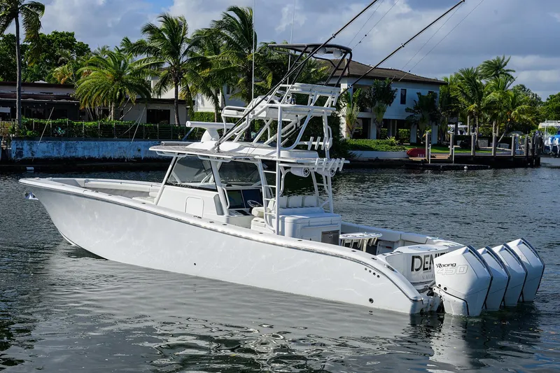 Denied Yacht Photos Pics 2021 Yellowfin 42 boat with multiple engines docked near palm trees.