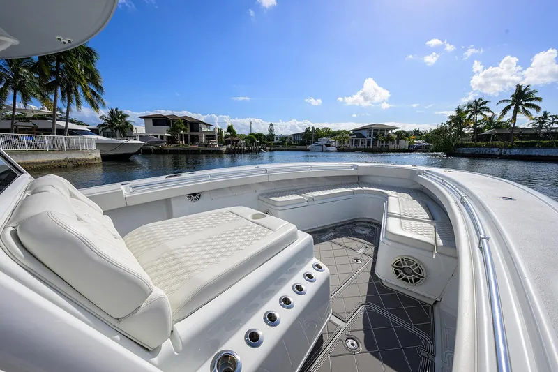 Denied Yacht Photos Pics 2021 Yellowfin 42 boat with luxurious seating, docked in a scenic waterfront location.
