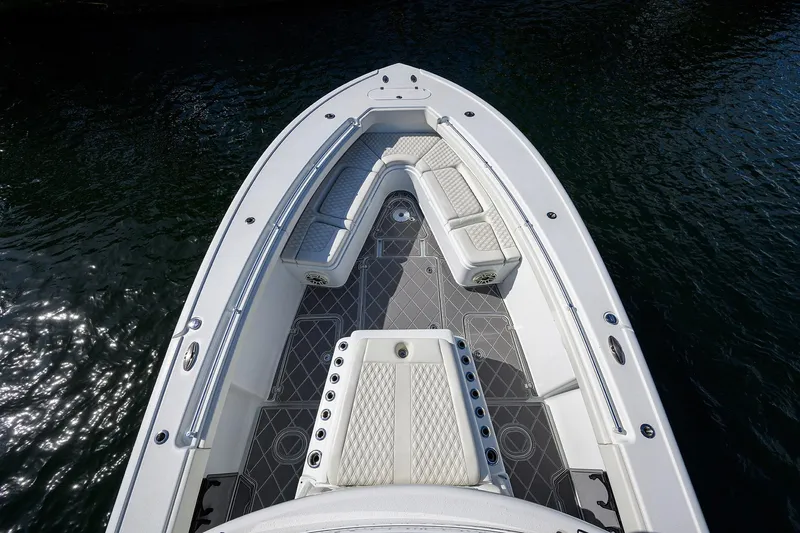 Denied Yacht Photos Pics 2021 Yellowfin 42 boat bow with cushioned seating and sleek design on water.