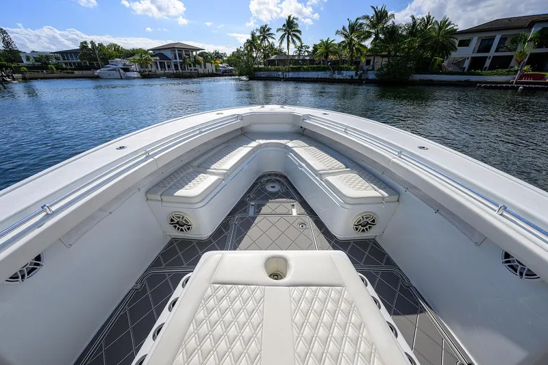 Denied Yacht Photos Pics 2021 Yellowfin 42 boat interior with luxurious seating on a scenic waterfront.