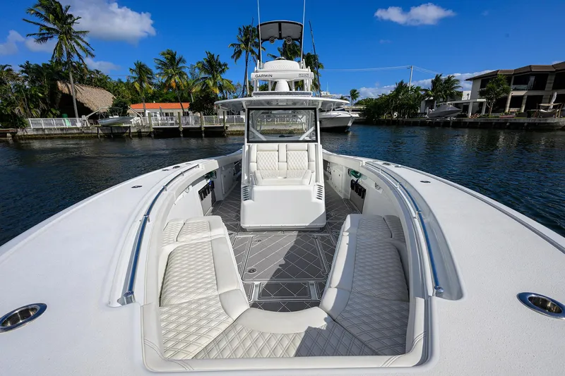 Denied Yacht Photos Pics 2021 Yellowfin 42 boat with luxurious seating, docked in a scenic waterfront location.