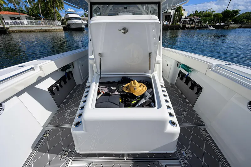 Denied Yacht Photos Pics 2021 Yellowfin 42 boat with open storage compartment, featuring a hat and gear inside.