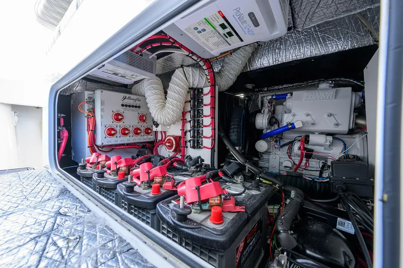 Denied Yacht Photos Pics Engine compartment of a 2021 Yellowfin 42 boat, showcasing batteries and wiring.