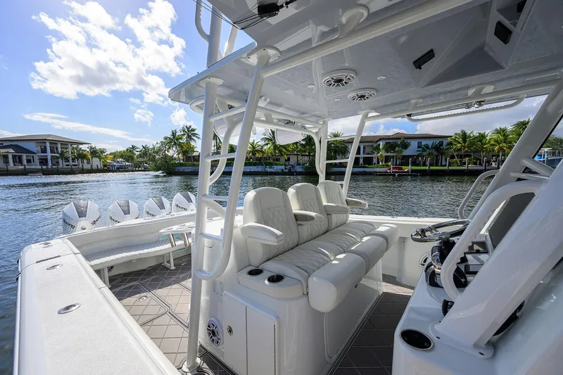 Denied Yacht Photos Pics 2021 Yellowfin 42 boat interior with luxurious seating and modern design on a sunny waterfront.