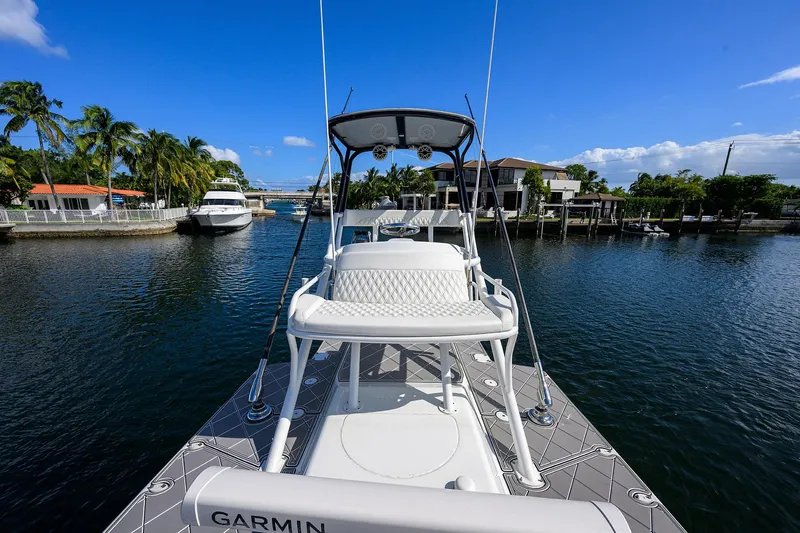 Denied Yacht Photos Pics 2021 Yellowfin 42 boat on a sunny waterfront, featuring Garmin equipment.