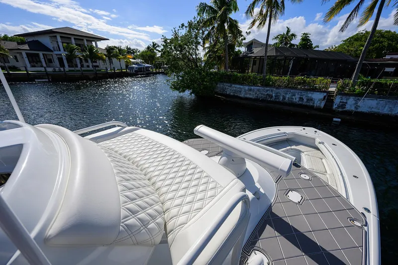 Denied Yacht Photos Pics Luxurious 2021 Yellowfin 42 boat with quilted seating, docked near tropical waterfront homes.