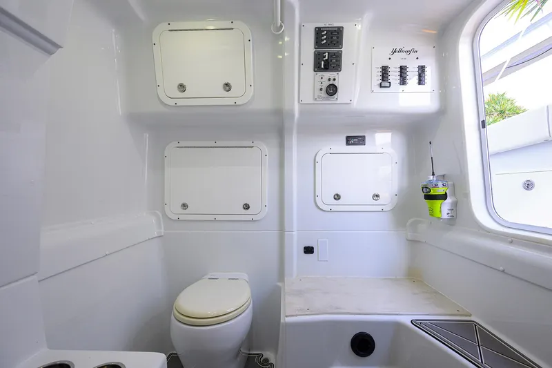Denied Yacht Photos Pics Interior of 2021 Yellowfin 42 boat featuring a compact bathroom with toilet and storage.