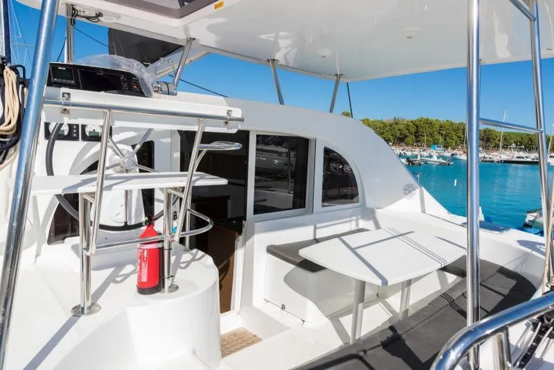 Yacht Photos Pics 2019 Lagoon 380 catamaran cockpit with seating, table, and ocean view.