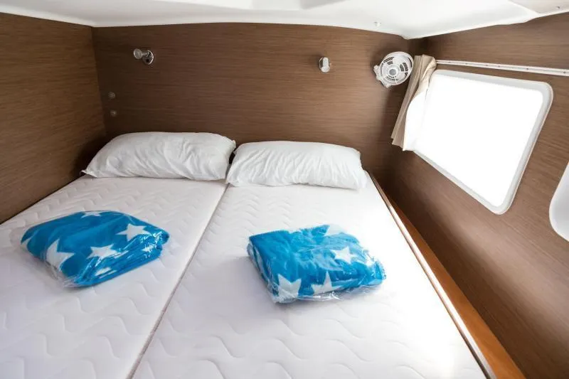  Yacht Photos Pics Interior cabin of 2019 Lagoon 380 catamaran with twin beds and window.