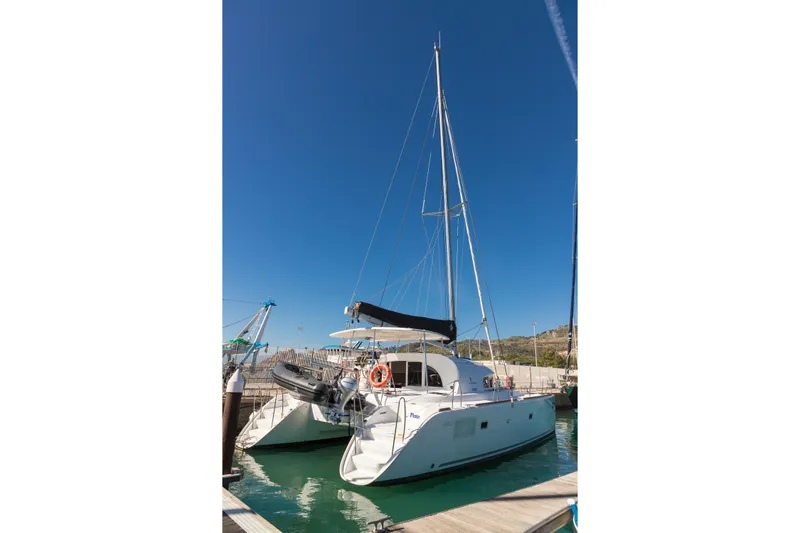  Yacht Photos Pics 2019 Lagoon 380 catamaran docked in marina under clear blue sky.
