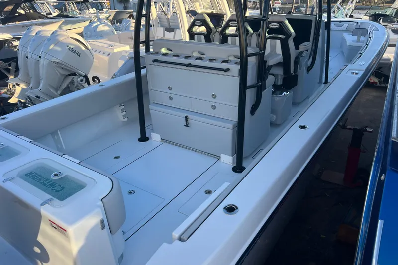  Yacht Photos Pics 2026 Contender 39 ST boat interior with seating and storage, docked alongside other boats.
