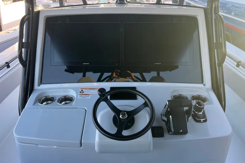  Yacht Photos Pics 2026 Contender 39 ST boat dashboard with dual Garmin displays and steering wheel.