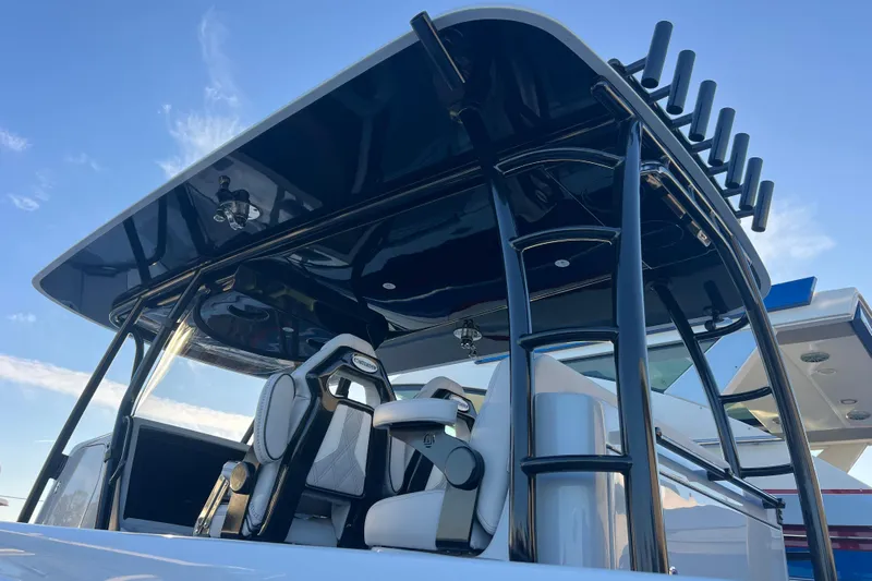  Yacht Photos Pics 2026 Contender 39 ST boat with sleek design and modern seating under a blue sky.