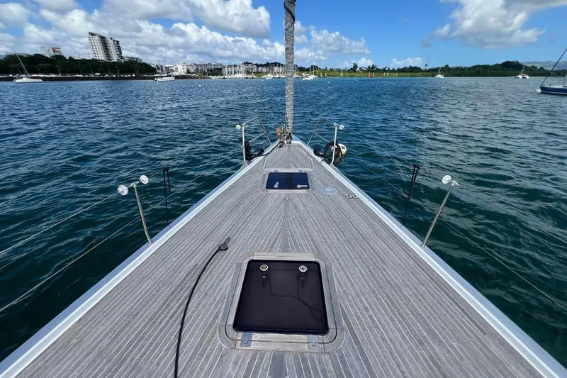 Ibubi Yacht Photos Pics Bow view of 2010 Grand Soleil 54 sailboat on calm waters under blue sky.