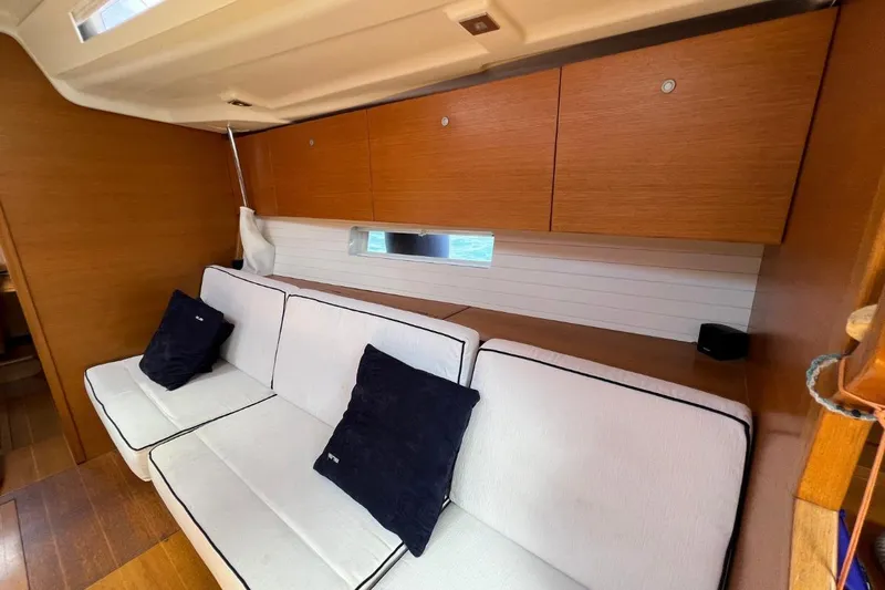 Ibubi Yacht Photos Pics Luxurious interior of 2010 Grand Soleil 54 yacht with white sofa and wooden cabinets.