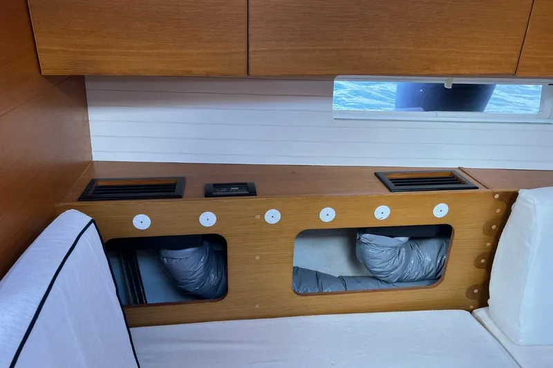 Ibubi Yacht Photos Pics Interior of 2010 Grand Soleil 54 yacht, featuring wooden cabinetry and a window view.