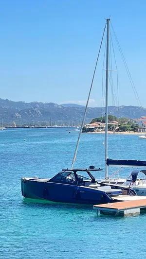 Yacht Photos Pics 2022 Evo Yachts R4 WA moored in clear blue waters with scenic mountain backdrop.