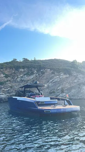  Yacht Photos Pics Evo Yachts R4 WA 2022 model on serene water with rocky shoreline backdrop.