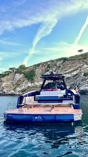  Yacht Photos Pics Luxury Evo Yachts R4 WA 2022 moored by rocky coastline under clear blue sky.