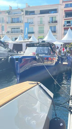  Yacht Photos Pics Evo Yachts R4 WA 2022 docked at marina with waterfront buildings in background.