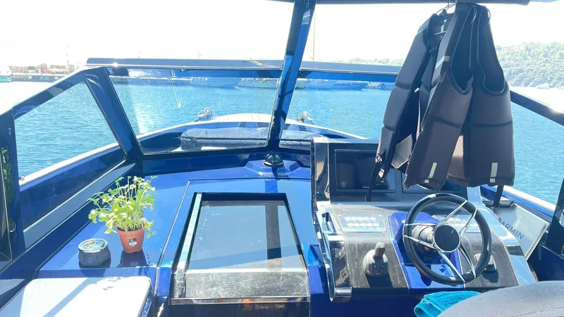  Yacht Photos Pics Cockpit of 2022 Evo Yachts R4 WA with steering wheel, life jackets, and potted plant.