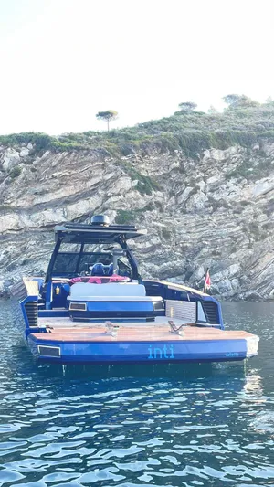  Yacht Photos Pics Evo Yachts R4 WA 2022 model anchored near rocky coastline.