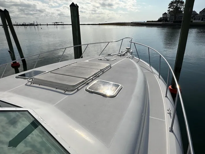  Yacht Photos Pics 2001 Tiara Yachts 4300 Open on calm water, docked at a marina.