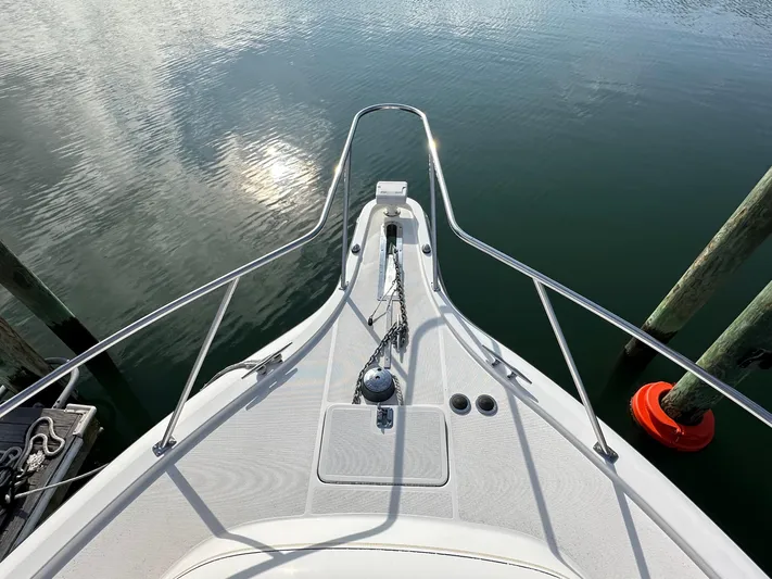  Yacht Photos Pics Bow view of 2001 Tiara Yachts 4300 Open, docked on calm water.