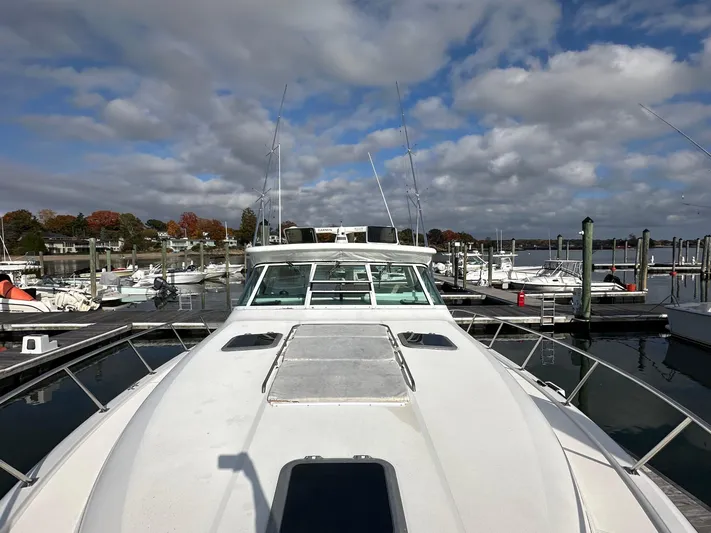  Yacht Photos Pics 2001 Tiara Yachts 4300 Open docked at a marina under a partly cloudy sky.
