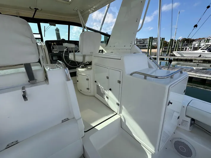  Yacht Photos Pics 2001 Tiara Yachts 4300 Open interior with white seating and helm, docked at marina.