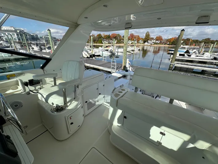  Yacht Photos Pics 2001 Tiara Yachts 4300 Open interior with marina view, featuring helm and seating area.