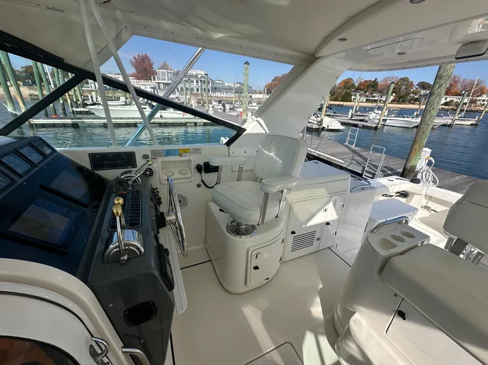  Yacht Photos Pics 2001 Tiara Yachts 4300 Open helm with white seating, docked at marina.