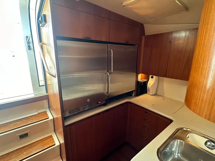  Yacht Photos Pics 2001 Tiara Yachts 4300 Open galley with wood cabinetry and stainless steel appliances.