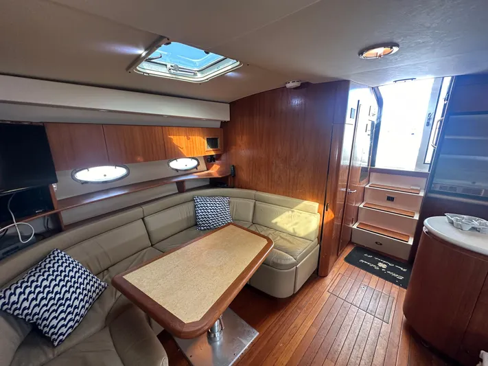  Yacht Photos Pics 2001 Tiara Yachts 4300 Open interior with cozy seating, wooden accents, and natural light.