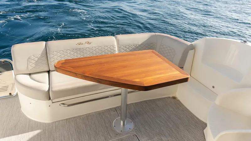O-sea-d Yacht Photos Pics Luxurious seating area on 2017 Sea Ray 51 Flybridge yacht with wooden table.