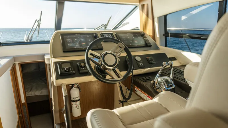 O-sea-d Yacht Photos Pics Helm of 2017 Sea Ray 51 Flybridge yacht with modern controls and ocean view.