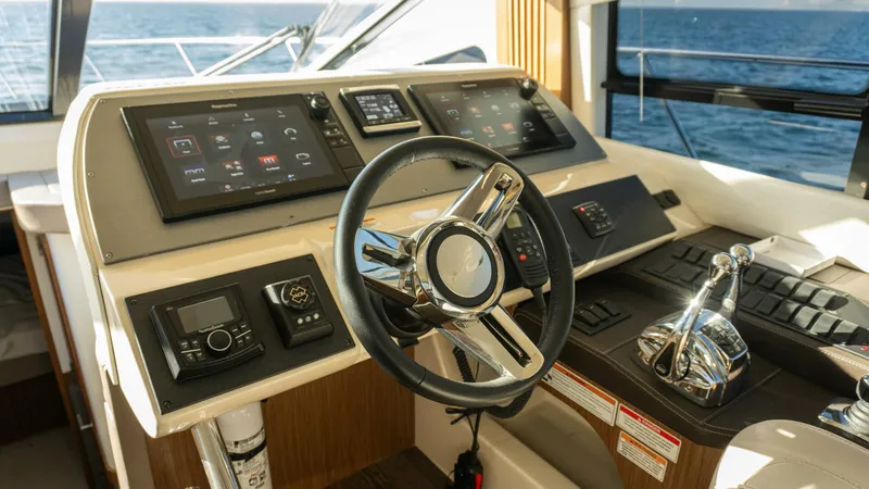 O-sea-d Yacht Photos Pics Cockpit of 2017 Sea Ray 51 Flybridge yacht with modern controls and steering wheel.